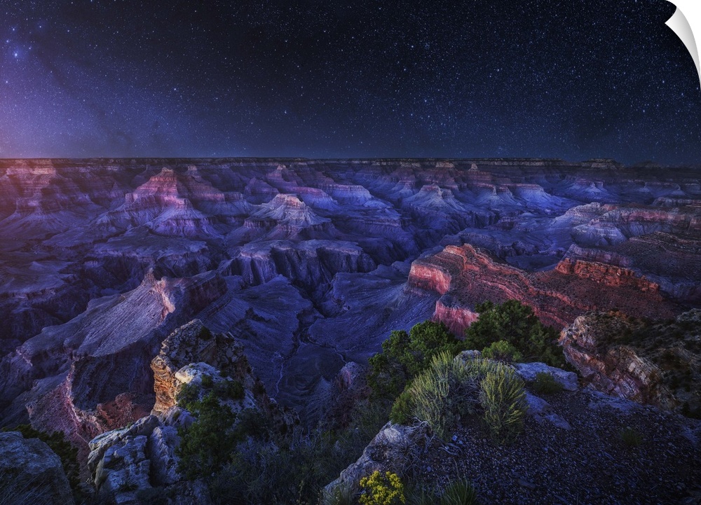 An intense dramatic photograph of the Grand Canyon under night sky, with every star seen.