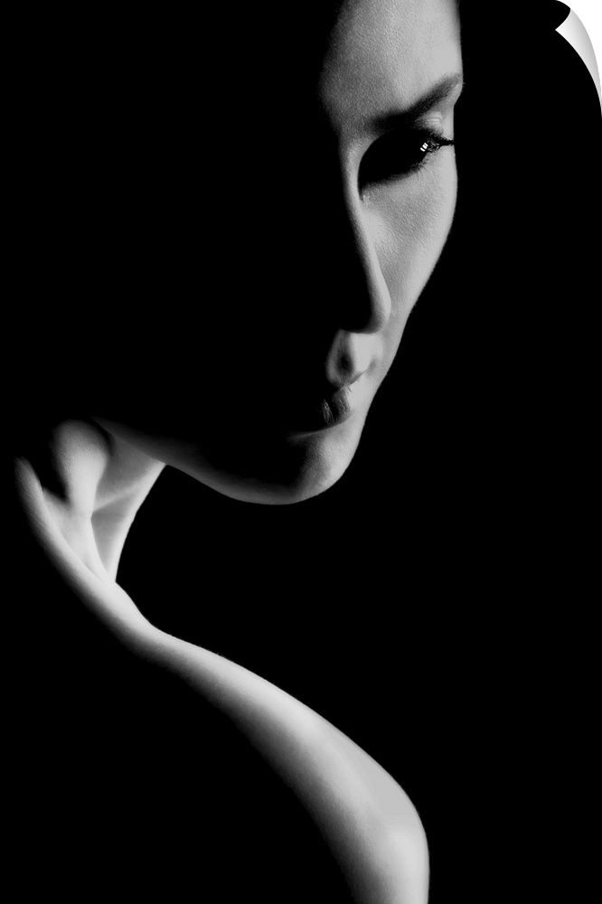Black and white portrait of a woman with stark contrast between light and shadows.