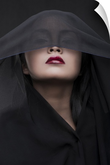 Portrait of a woman with red lipstick and a black veil over her eyes.