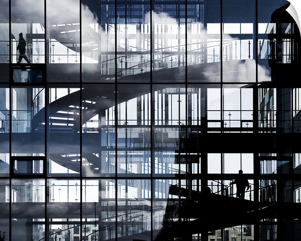 Abstract image created by a spiral staircase and glass windows of a buildling.