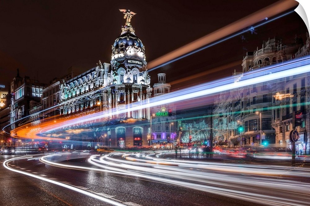 A night view of Madrid with neon light trails covering the air, Spain.