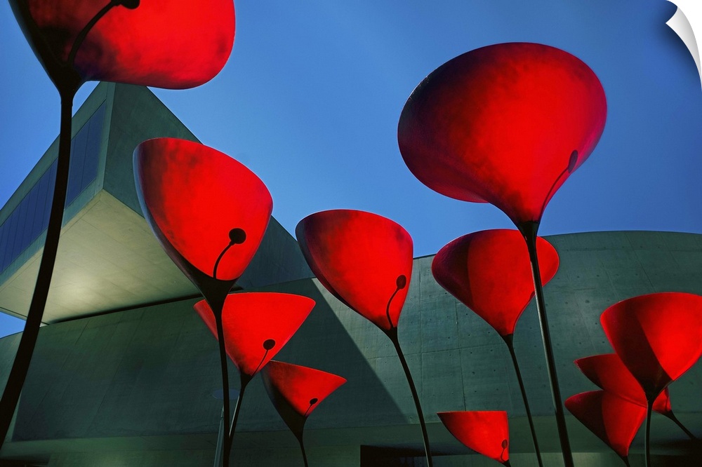Red sculptures outside a museum resembling flowers, Rome.