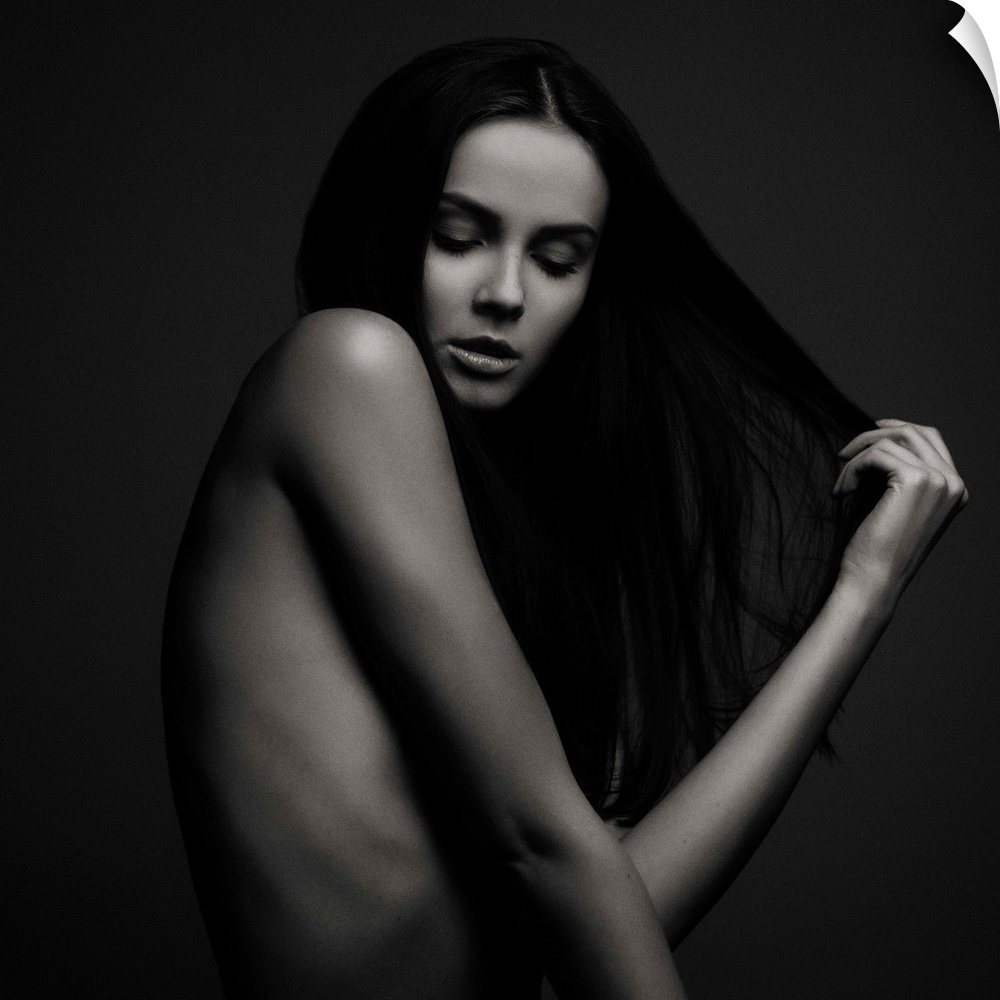 Nude portrait of a beautiful woman with long dark hair.