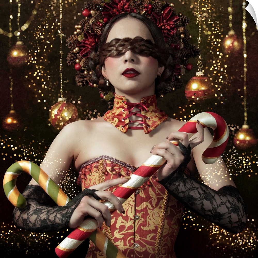 Conceptual image of a woman in a corset and elaborate hairstyle holding candy canes in front of hanging tree ornaments.