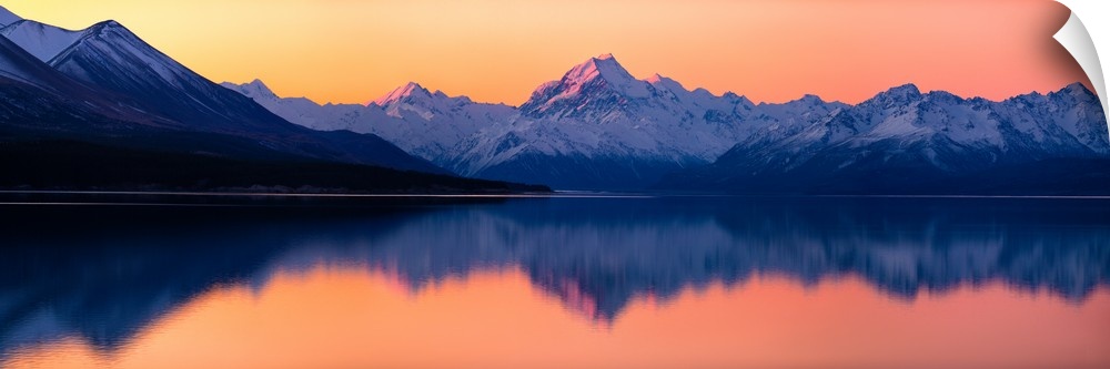 Mount Cook at sunset reflecting in a lake below, New Zealand.