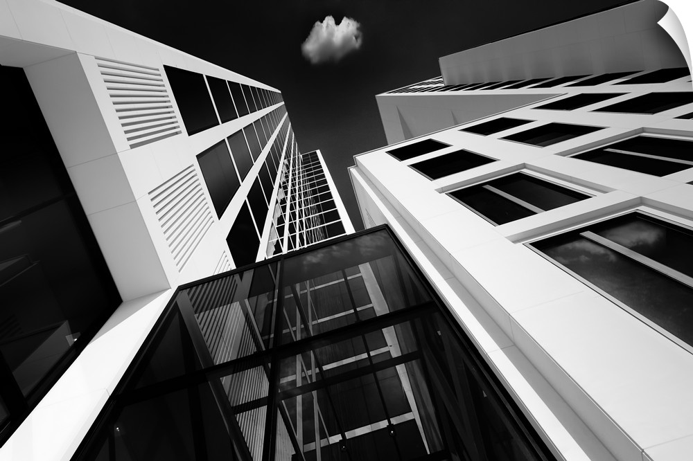 A black and white photograph looking up at tall skyscrapers in Germany.