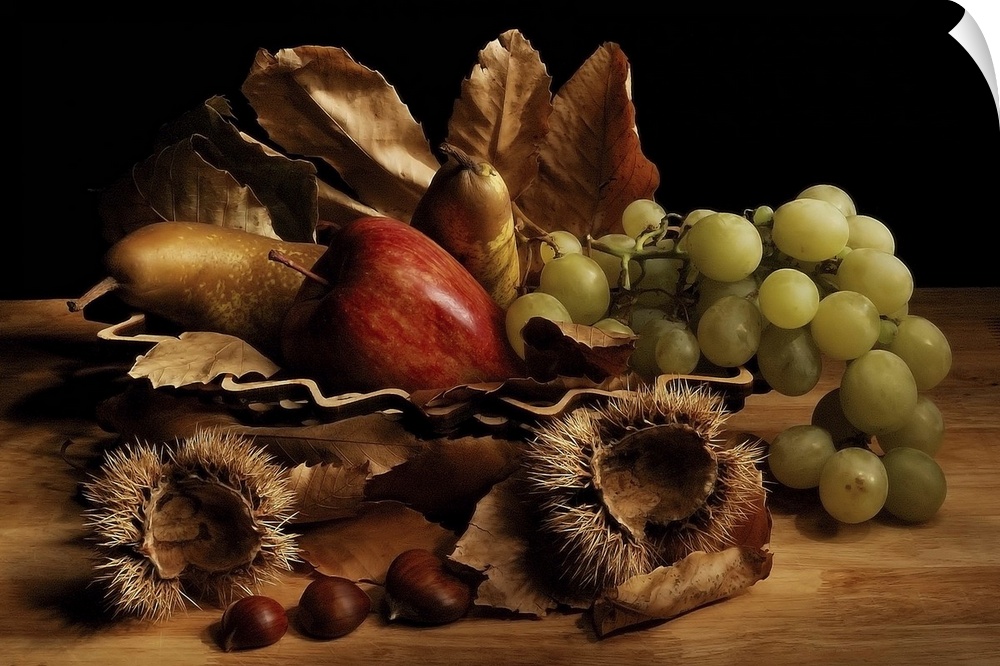 Still life arrangement with green grapes, a red apple, pears, fallen leaves, and chestnuts with their spiky coverings.
