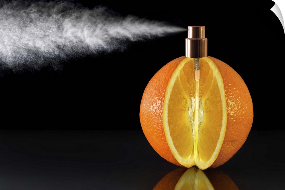 Conceptual photograph of an orange with a wedge cut of it and a spray nozzle fitted to the top of it.