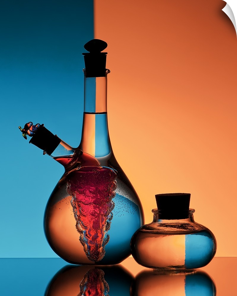 Two glass jars of oil and vinegar reflecting backwards images of the orange and blue walls in the background.