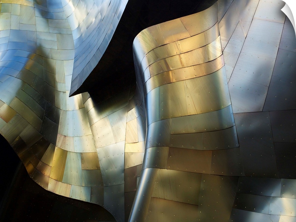 A photograph of an abstract view of a curved metal building facade.