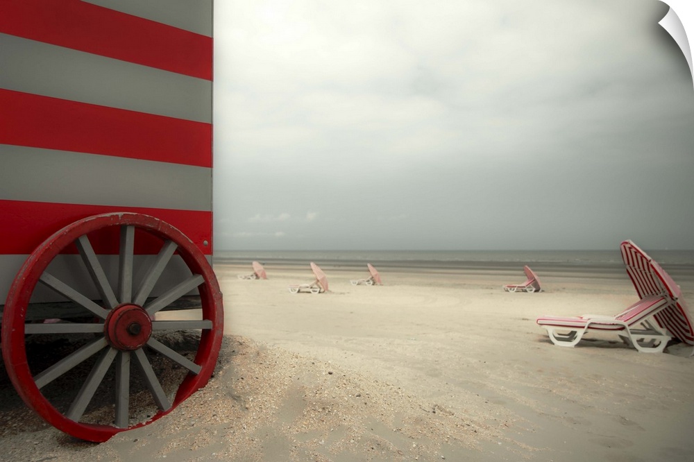 Beach scene with umbrellas and a red striped beach hut.