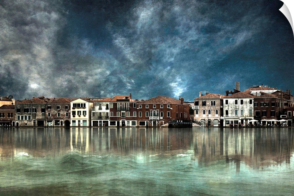 Row of buildings along the canal in Venice, Italy, with dark clouds overhead.