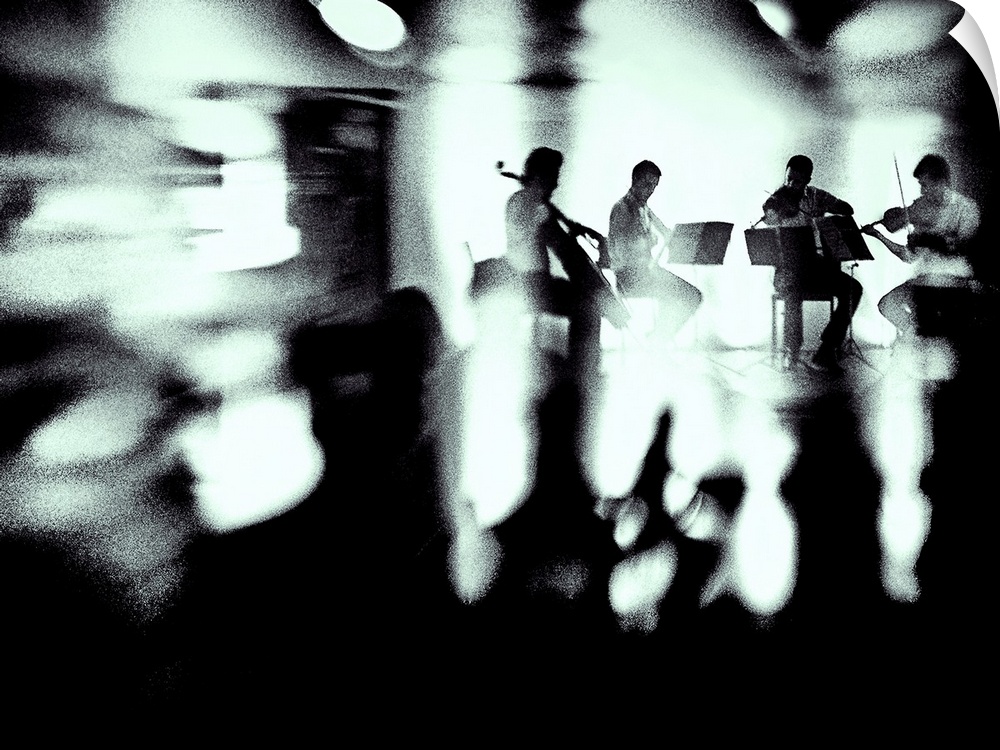 A quartet of musicians plays a piece, surrounded by blurred lights and shadows.