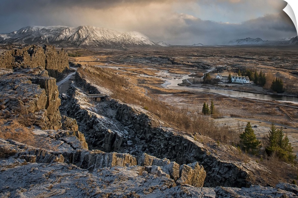 A small village can be seen in the distance of this desolate looking Icelandic rift valley.