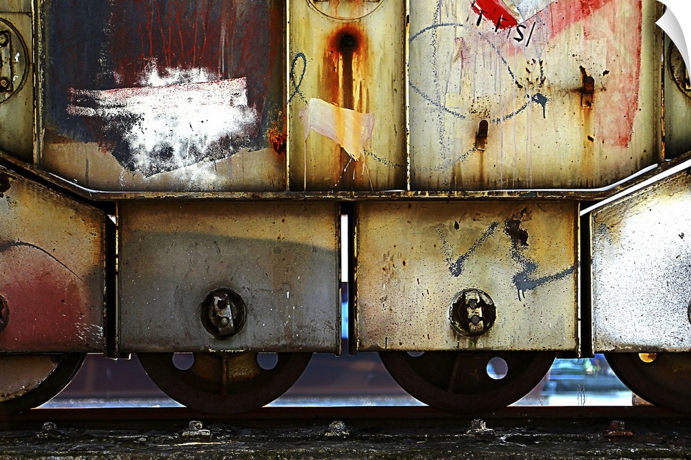 A fine art photograph of a graffiti'd train car sitting on the rails.