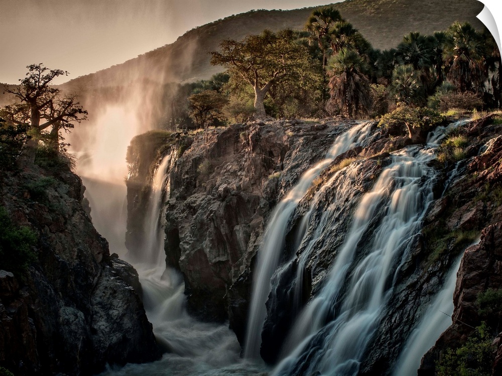 Rushing waterfalls flowing over rocks cliffs in Africa.
