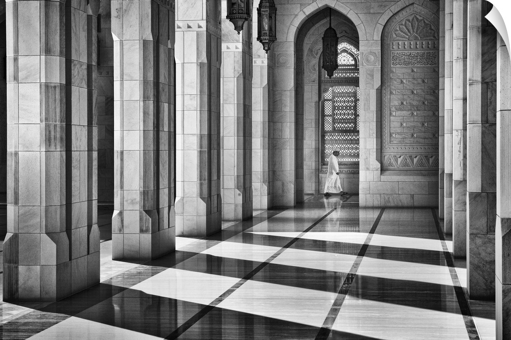 Dramatic shadows cast by intricate architecture of a mosque hit by sunlight, Oman.