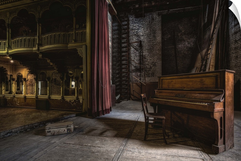 A derelict theatre with an old piano and chair on stage.