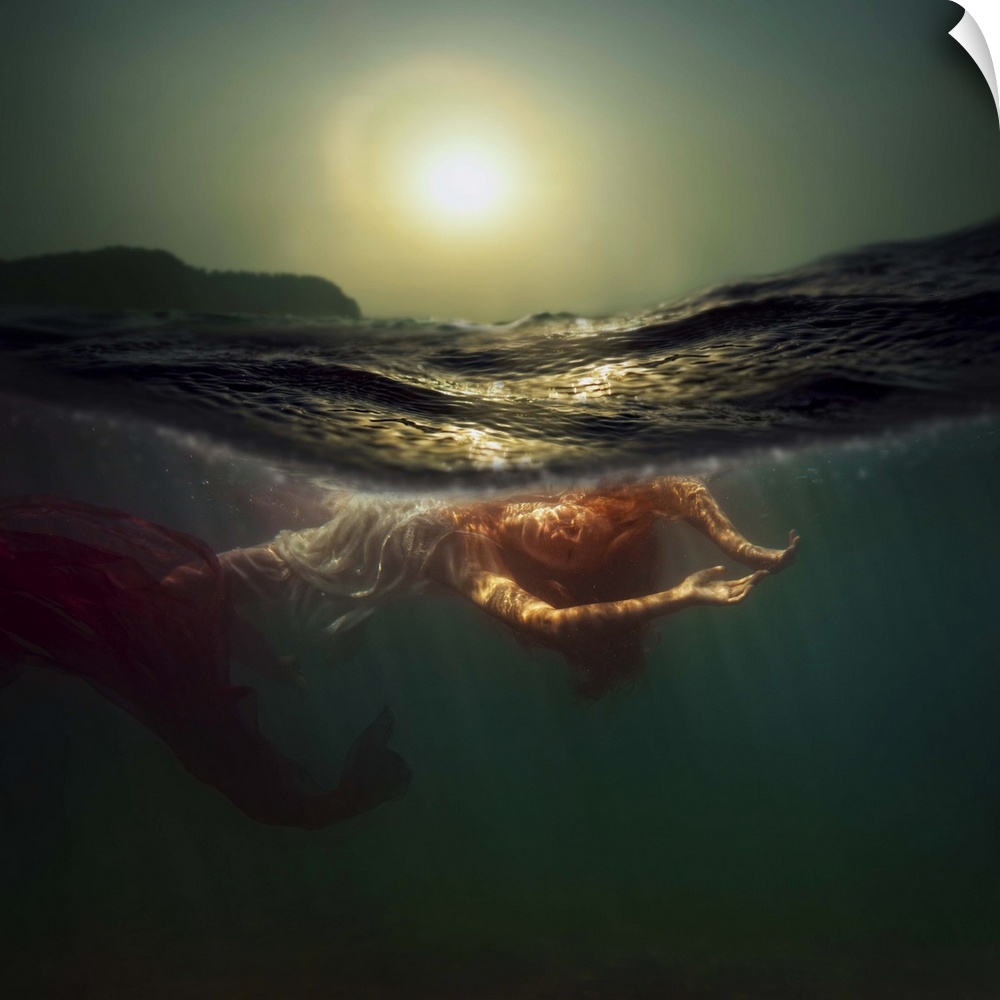 Underwater photo of a woman swimming beneath the surface, resembling a mermaid.