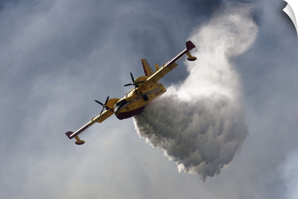 A CanadAir fire plane releasing tons of water in the sky.