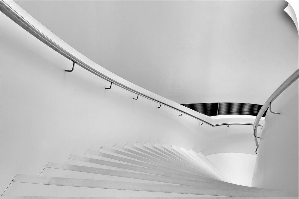 A stairway with metal railings and white walls.