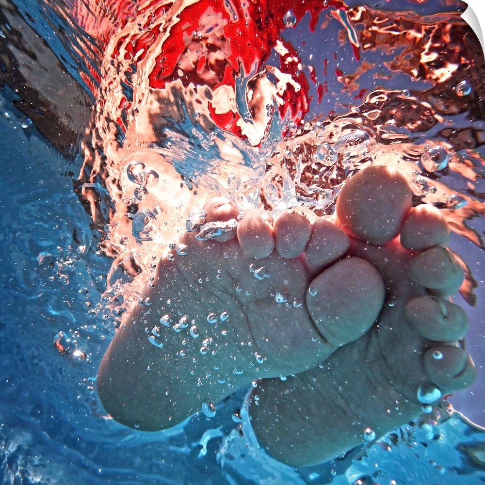 Underwater photograph of a feet splashing around.