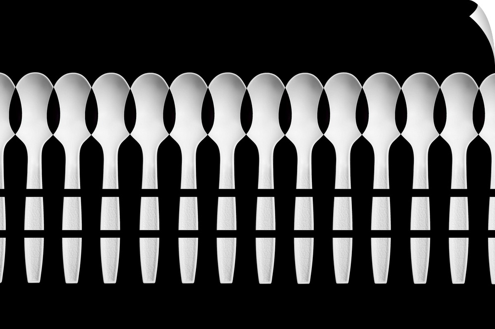 An abstract pattern created by a multitude of white plastic spoons.