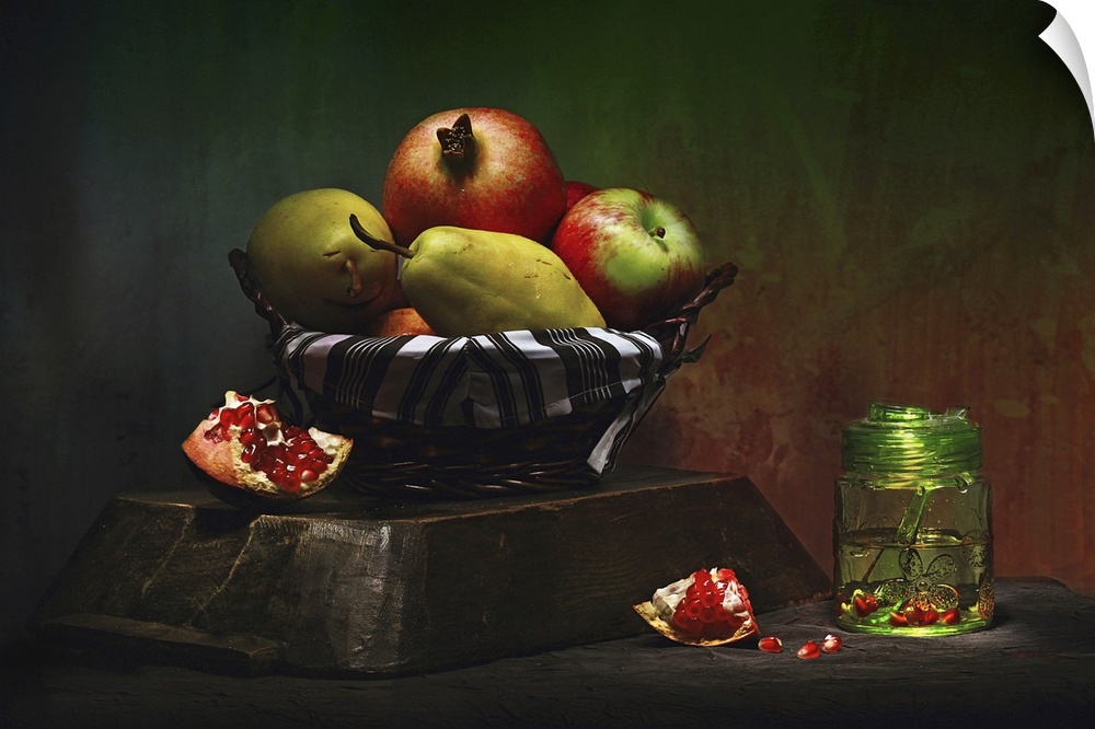 Still life photo of a basket of fruit, including pears and pomegranates.