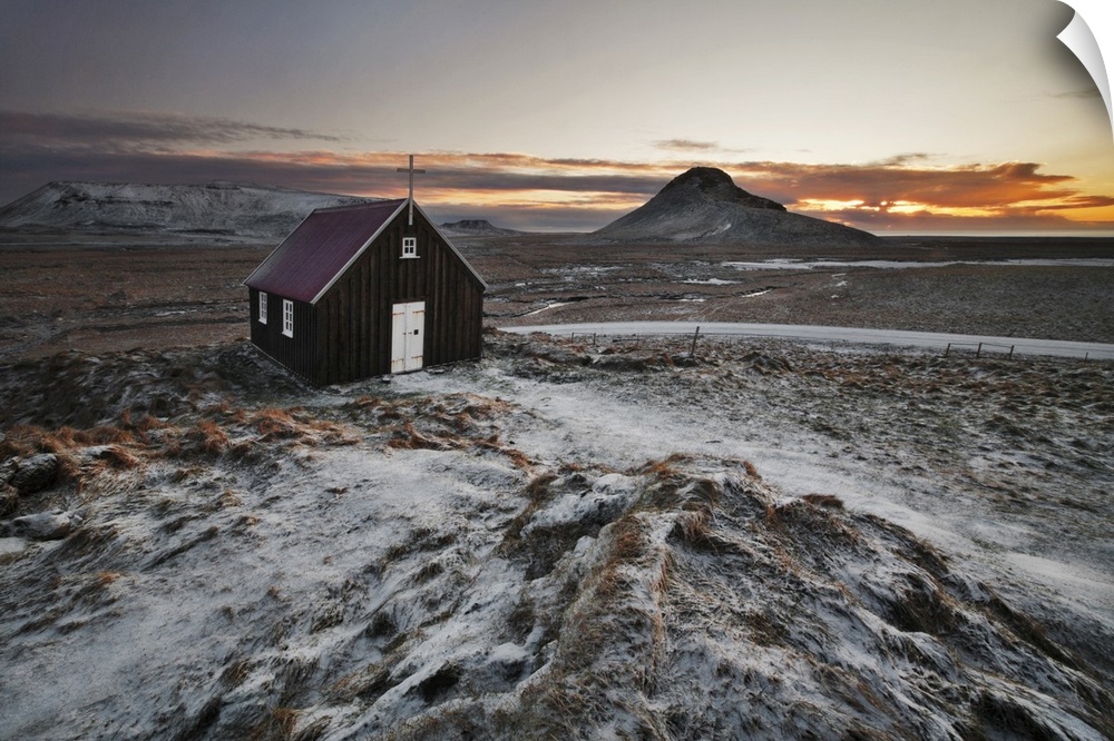 Small church in the icy rural landscape of Iceland, during sunset.