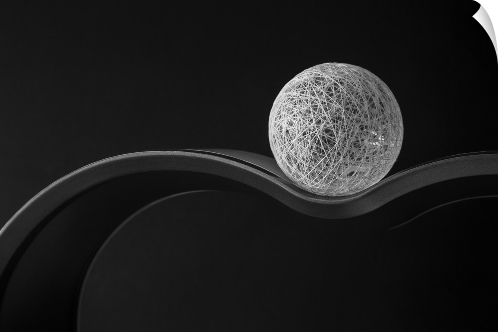 A ball of string resting on a curved surface.