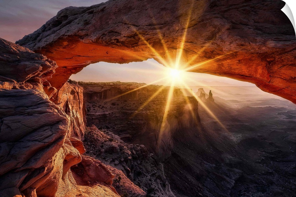 A view through the Mesa Arch in the Canyonlands national park in Utah at sunrise.