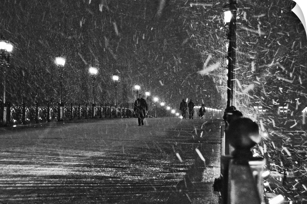 People walking over a bridge in Moscow, Russia, during a snowstorm.