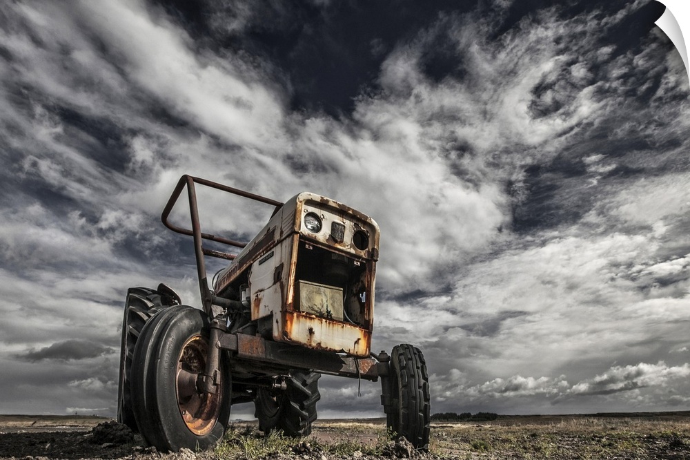 A derelict farming tractor in a desolate field, Iceland.