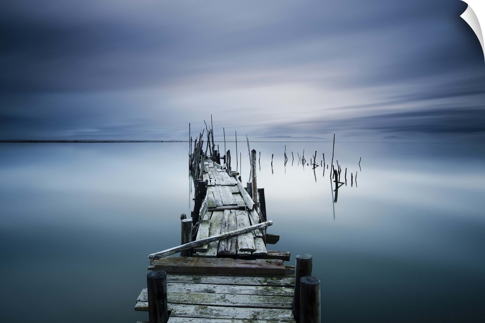 A weathered wooden pier over the calm waters in Carrasquiera, Portugal.