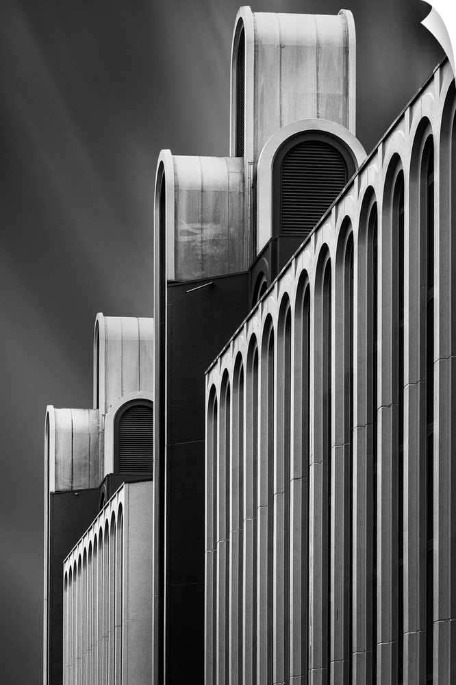 Black and white image of the facade of a a structure, creating an abstract image.