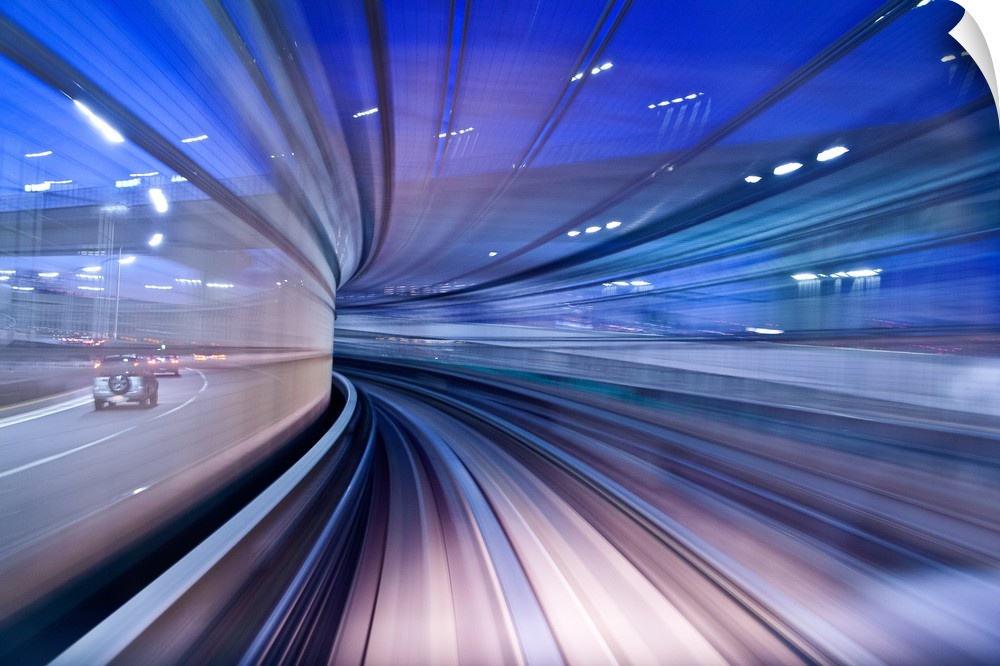 Blurred motion image of a highway in the evening, creating the illusion of being in a tunnel.
