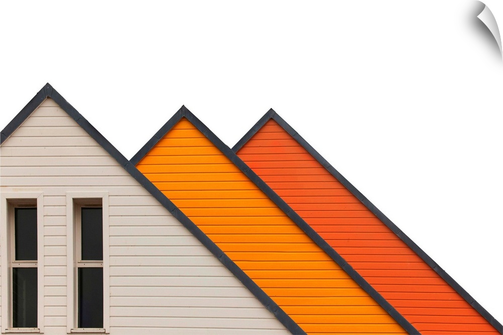 Architectural abstract photograph of three a-frame structures in white and shades of orange.