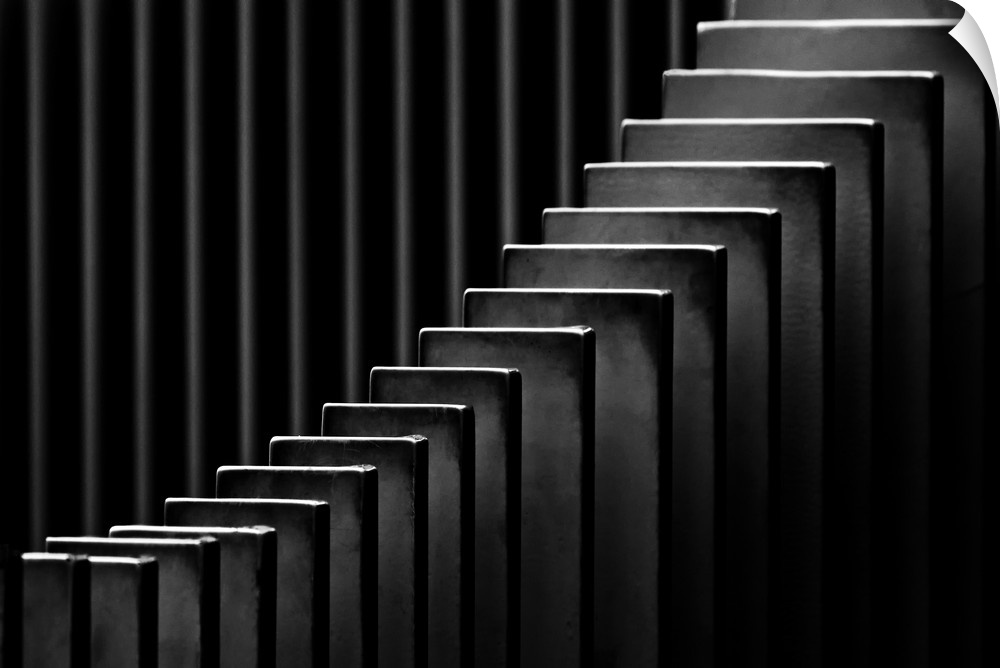 Abstract black and white photograph with leading lines made up of rectangular slits.