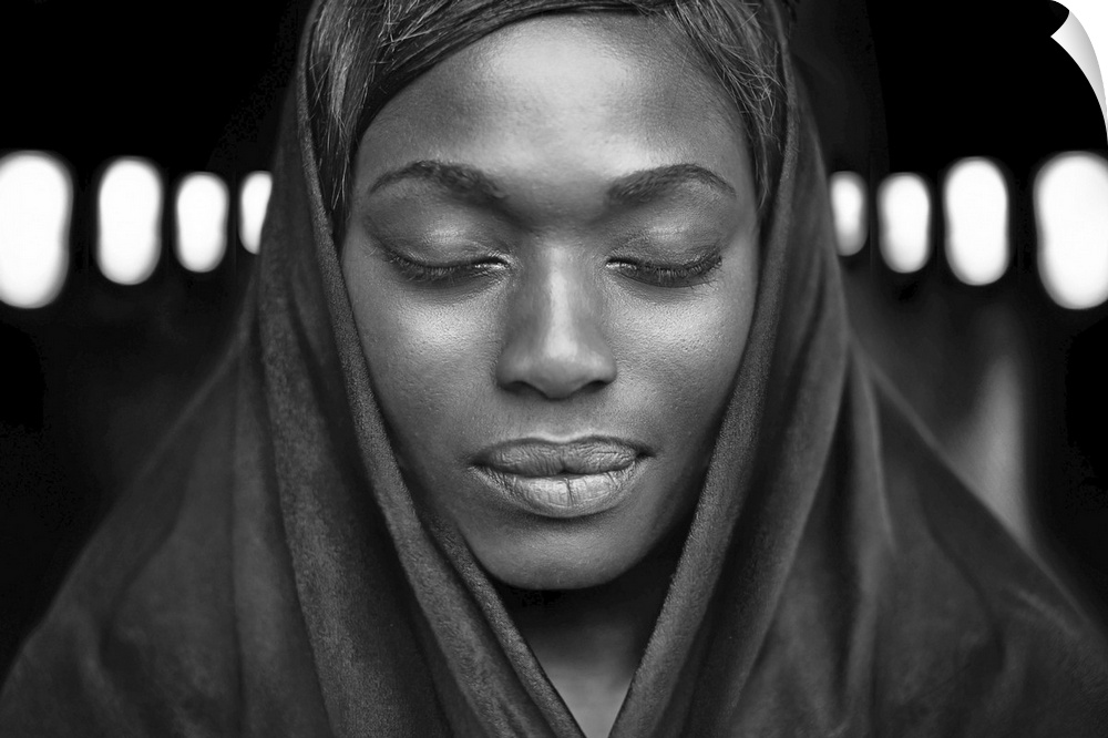 Black and white portrait of a beautiful dark-skinned woman with eyes closed.
