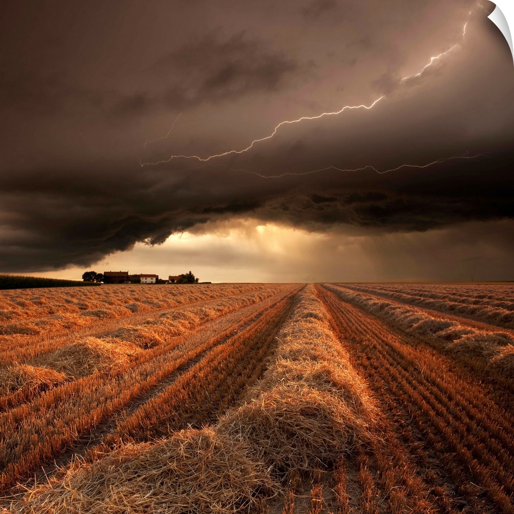A countryside farmland under a cloudy lightning filled sky.