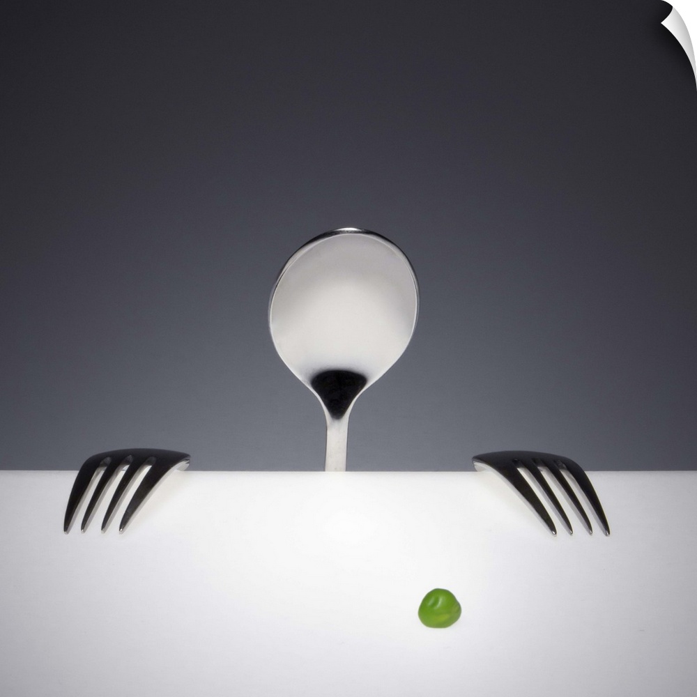 A spoon and two forks arranged to resemble a person looks at a single green pea.