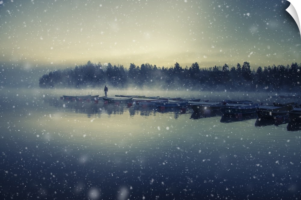 Landscape photograph of a row of docked boats during a snow storm in Finland.