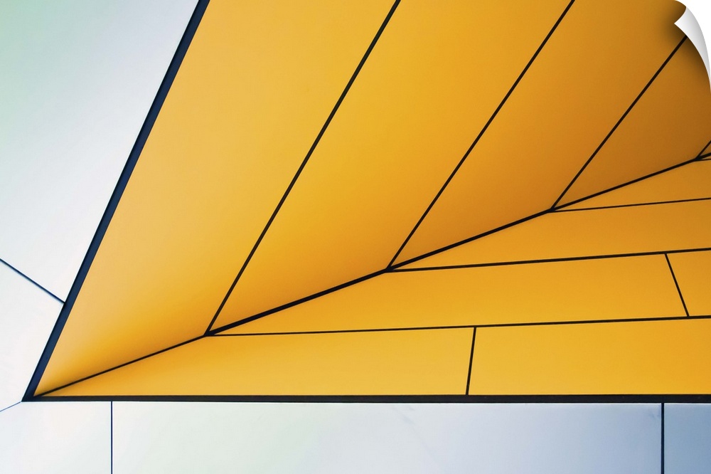 Yellow and white panels on an angular wall creating an abstract image.