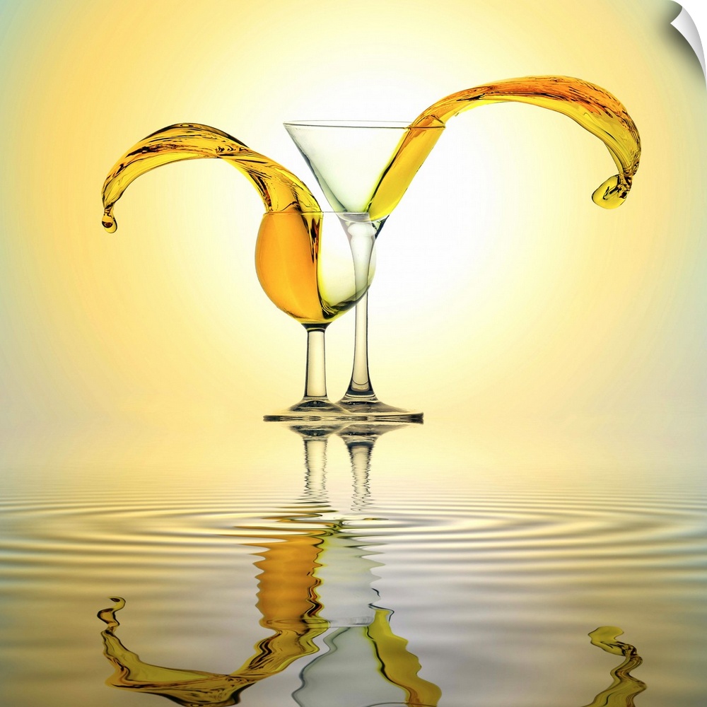 Conceptual image of two glasses with orange liquid spilling out of them.