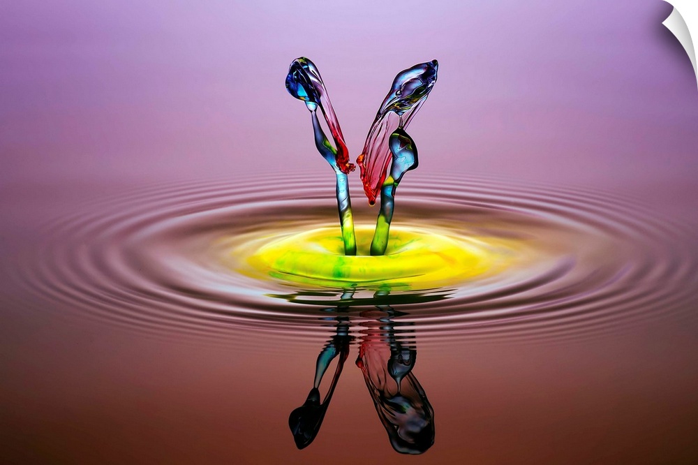 A macro photograph of a colorful splash of a droplet of water.