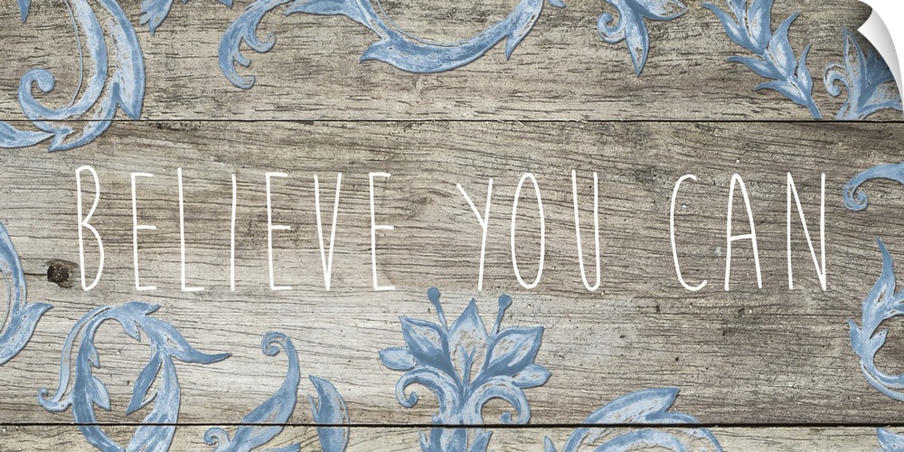 "Believe you can" in thin letters on a wooden plank with blue florals.