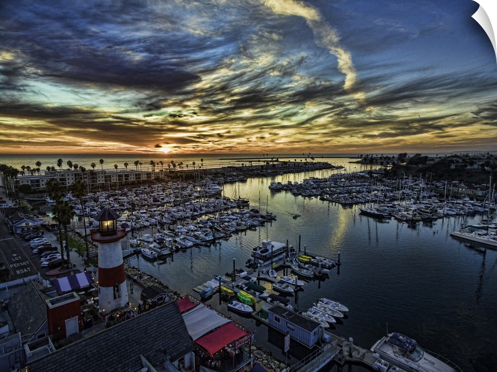 The little lighthouse in Oceanside Harbor glows in this colorful aerial sunset in Oceanside, California, USA.