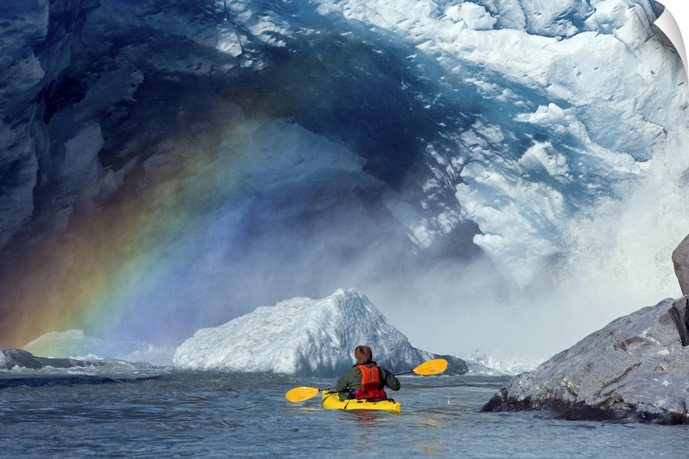A kayaker explores a melt stream gushing from beneath Mendenhall Glacier, Mendenhall Lake, Tongass National Forest, Juneau...