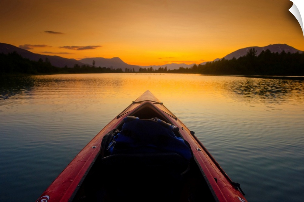A Kayaker's Perspective While Crossing A Calm Lake At Sunset, Alaska