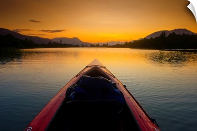 A Kayaker's Perspective While Crossing A Calm Lake At Sunset, Alaska